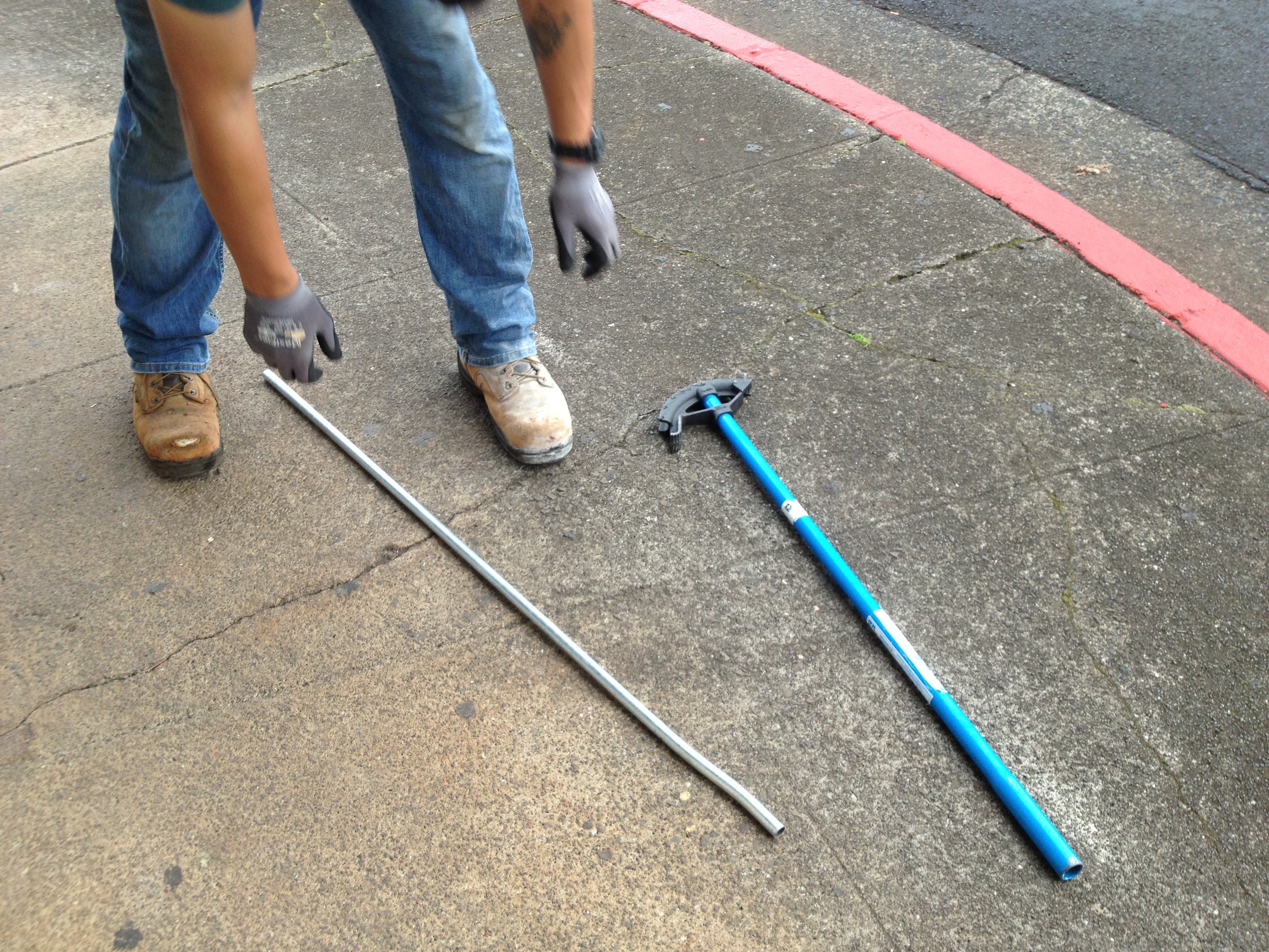JM Electric team member with conduit bender on job site