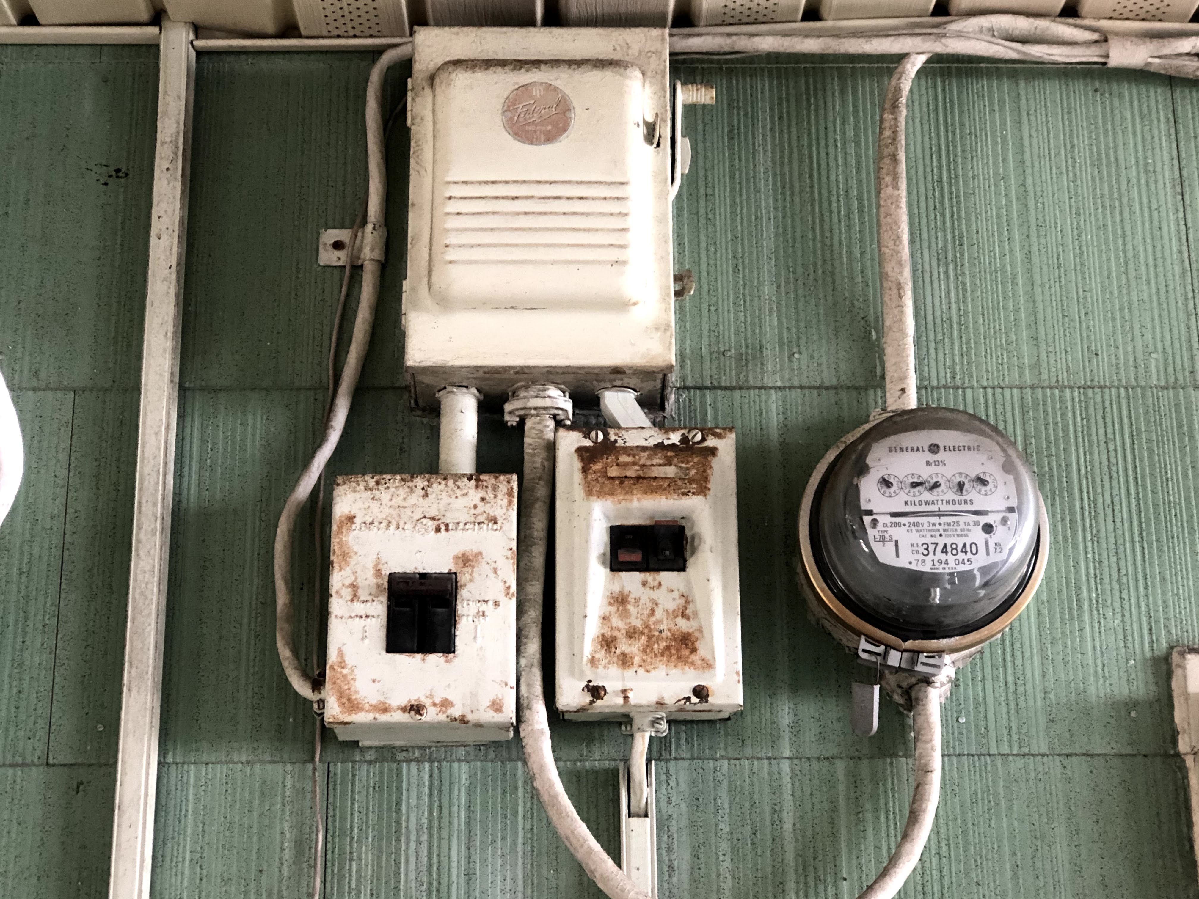 Rusty fuse box and meter before panel upgrade - Oahu