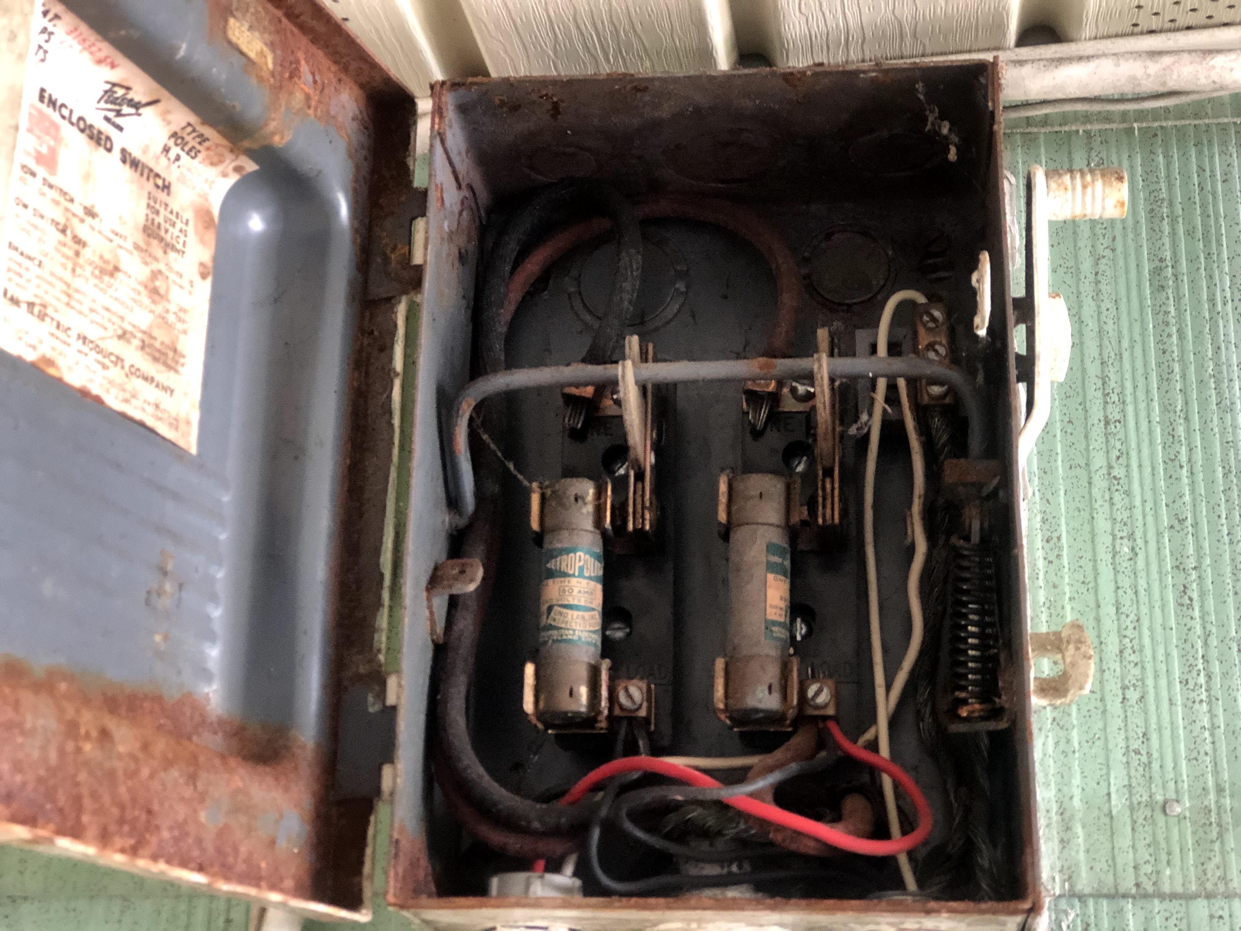 Very old rusty enclosed switch fuse box requiring full replacement